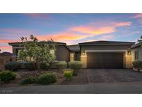 Charming single-story home featuring desert landscaping, a paver driveway and walkway, and a two car garage at 6421 Winecup St, Las Vegas, NV 89149