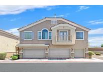Inviting townhome featuring a three-car garage, charming balcony, and traditional architecture at 6559 Tumbleweed Ridge Ln # 103, Henderson, NV 89011