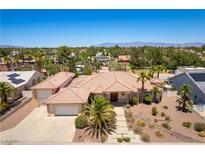 Stunning single-story home featuring a tile roof, desert landscaping, and a three-car garage at 7250 Birkland Ct, Las Vegas, NV 89117