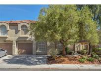 Charming townhome exterior with well-maintained landscaping and attached two-car garage at 7716 Bauble Ave, Las Vegas, NV 89128