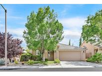 Charming single-story home with a well-manicured lawn and a mature tree in the front yard at 9517 Mountainair Ave, Las Vegas, NV 89134