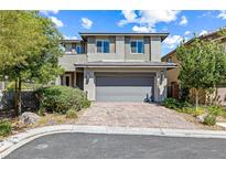 Charming two-story home featuring manicured landscaping, brick driveway, and a gray two-car garage at 7017 Pearl Hilltop Ct, Las Vegas, NV 89148