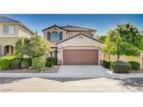 Charming two-story home featuring a two-car garage and manicured landscaping at 1013 Brinkman St, Las Vegas, NV 89138