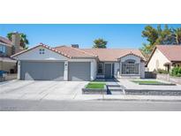 Charming single-story home featuring a tile roof, a two-car garage, and low-maintenance landscaping at 1553 Bright View Dr, Las Vegas, NV 89119