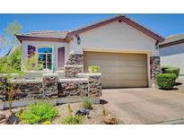 Charming single story home with stone accents and well-maintained landscaping at 169 Pioneer Peak Pl, Las Vegas, NV 89138