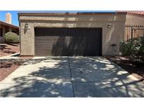 Exterior view of the two-car garage with brown garage door at 1866 Camino Verde Ln, Las Vegas, NV 89119