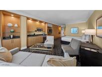 Relaxing living area with wet bar, comfortable seating, and a sleeping area in a cozy modern setting at 2000 N Fashion Show Dr # 5417, Las Vegas, NV 89109