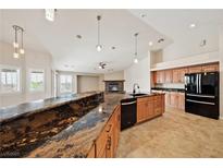 Open kitchen features granite countertops, stainless appliances, and seamless flow into the living area at 2031 Silver St, Pahrump, NV 89048
