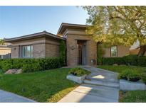 Charming single-story home with stone accents, manicured lawn, and mature landscaping creating a welcoming curb appeal at 2797 Turtle Head Peak Dr, Las Vegas, NV 89135