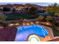 Gorgeous backyard pool and landscaping overlook golf course views and mountainous scenery at twilight at 2837 Turtle Head Peak Dr, Las Vegas, NV 89135