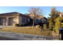 Charming single-story home with a two-car garage, well-manicured lawn, and desert landscaping at 35 Emerald Dunes Cir, Henderson, NV 89052