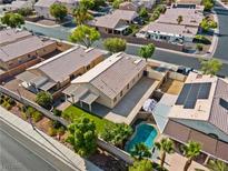 An aerial view of a charming single-story home with a refreshing pool and well-maintained landscaping at 5115 Morning Splash Ave, Las Vegas, NV 89131