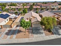 Inviting single-story home featuring a well-manicured lawn and a two car attached garage at 5115 Morning Splash Ave, Las Vegas, NV 89131