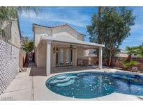 Outdoor pool and patio area offering a private retreat with a covered seating area and steps into the water at 5811 Pack Trl, Las Vegas, NV 89118