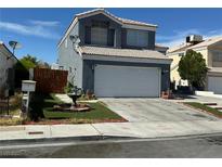 Charming two-story home with a well-maintained yard, spacious driveway, and tile roof at 6208 Mandarin Dr, Las Vegas, NV 89108