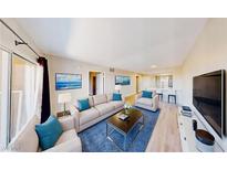 Bright living room featuring stylish furniture, blue accent pillows, and sleek decor creating an inviting space at 8070 W Russell Rd # 1046, Las Vegas, NV 89113