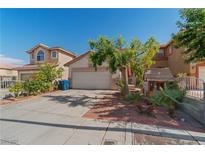 Charming home features a two-car garage, mature tree, and a quaint playhouse at 8509 W Rochelle Ave, Las Vegas, NV 89147