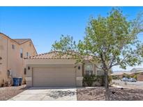 Charming single-story home features a two-car garage and a mature tree in the front yard at 9644 Flying Eagle Ln, Las Vegas, NV 89123