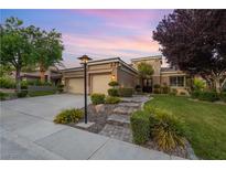 Charming single-story home with a well-manicured lawn, desert landscaping, and a paved walkway leading to the front door at 1016 Sable Mist Ct, Las Vegas, NV 89144