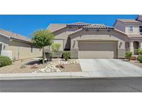 Charming single-story home with a well-maintained front yard and a two-car garage at 1076 Crescent Falls St, Henderson, NV 89011