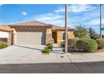 Charming single-story home with desert landscaping, tile roof, stone accents, and attached two-car garage at 11253 Revelry Ln, Las Vegas, NV 89138