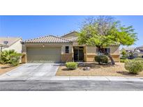 Charming single-story home featuring a xeriscaped front yard and two-car garage at 1208 Neva Ranch Ave, North Las Vegas, NV 89081