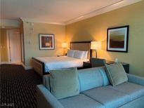 Comfortable bedroom area with king bed, sofa, and warm lighting for a relaxing stay at 2000 N Fashion Show Dr # 2627, Las Vegas, NV 89109