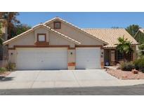 Charming single-story home featuring a two-car garage and well-maintained desert landscaping at 241 Honeywood St, Henderson, NV 89074