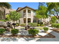Stunning two-story building with a stone picnic bench, beautiful landscaping and a gorgeous mountain view at 3451 Desert Cliff St # 103, Las Vegas, NV 89129