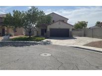 Charming two-story home featuring a well-manicured lawn and an extended driveway at 6043 Cape Clairmont Ct, North Las Vegas, NV 89031