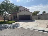 Inviting home featuring a two-car garage, low-maintenance landscaping, and a spacious driveway for additional parking at 6043 Cape Clairmont Ct, North Las Vegas, NV 89031