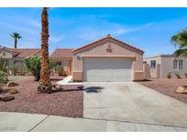 Charming single-story home with a two-car garage and desert landscaping in a sunny neighborhood at 612 Moontide Ct, Henderson, NV 89011