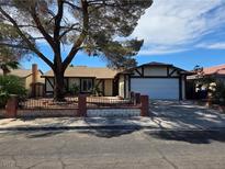 Charming single-story home featuring mature tree, two-car garage, and inviting front yard in a residential neighborhood at 6402 Agua Dr, Las Vegas, NV 89103