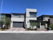 Modern two-story home featuring a two-car garage, stone accents, and contemporary architectural details at 6927 Desert Finch St, North Las Vegas, NV 89084