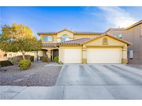 Charming two-story home with a three-car garage and a well-manicured front yard with mature landscaping at 7317 Wild Roar Ave, Las Vegas, NV 89129