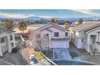 Charming two-story home in a residential area, featuring a well-manicured lawn and attached garage at 9879 Jazzy June St, Las Vegas, NV 89183