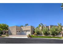 Inviting exterior of home featuring a three-car garage, mature landscaping, and neutral stucco at 2017 Slow Wind St, Las Vegas, NV 89134