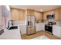 Bright kitchen features stainless steel appliances, modern cabinets, and white countertops at 233 Pecos Way, Las Vegas, NV 89121