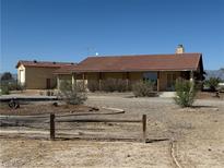 Charming ranch-style home with desert landscaping and spacious front yard at 3090 N Woodchips Rd, Pahrump, NV 89060