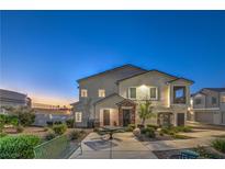 Inviting home exterior featuring a charming covered porch, meticulous landscaping, and warm exterior lighting at 545 Thea St # 1315, Henderson, NV 89052