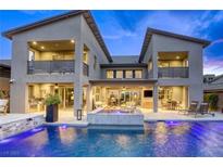 Gorgeous backyard pool featuring a waterfall feature and outdoor kitchen, perfect for entertaining at 6570 Aurora View St, Las Vegas, NV 89135