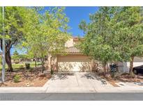 Charming two-story home featuring a tile roof, desert landscaping, and an attached two-car garage at 7621 Breed Hill St, Las Vegas, NV 89149