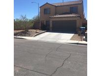 Charming two-story home featuring a tile roof and a two-car garage with a private driveway at 9175 Titan Hill Ct, Las Vegas, NV 89148