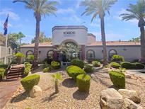 Horizons Clubhouse exterior featuring desert landscaping, palm trees, and American flag in a sunny, pleasant setting at 950 Seven Hills Dr # 217, Henderson, NV 89052