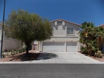 Two-story home with a two-car garage and desert landscaping at 1018 Sun Poppy Ave, Las Vegas, NV 89123