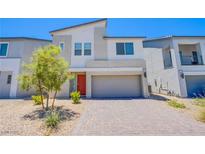 Charming two-story home featuring a modern elevation, a two-car garage and desert landscaping at 10435 Rose Palisade St, Las Vegas, NV 89141