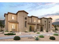 Beautiful multi-level townhouse with a neutral stucco facade, stone accents, desert landscaping, and a tiled roof at 188 Wewatta Ave, Henderson, NV 89011