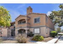 Charming two-story condo with a red tile roof and stucco exterior, offering a cozy and inviting curb appeal at 220 Mission Catalina Ln # 208, Las Vegas, NV 89107