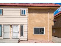 Charming exterior of a two-story home featuring a red tile roof and neutral-toned siding at 2915 Cedar Ave # 12C, Las Vegas, NV 89101