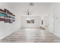 Bright living room featuring wood-style flooring, a ceiling fan, and white walls at 2915 Cedar Ave # 12C, Las Vegas, NV 89101